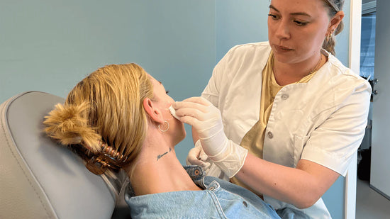 Kvinde får lavet en behandling af sygeplejerske